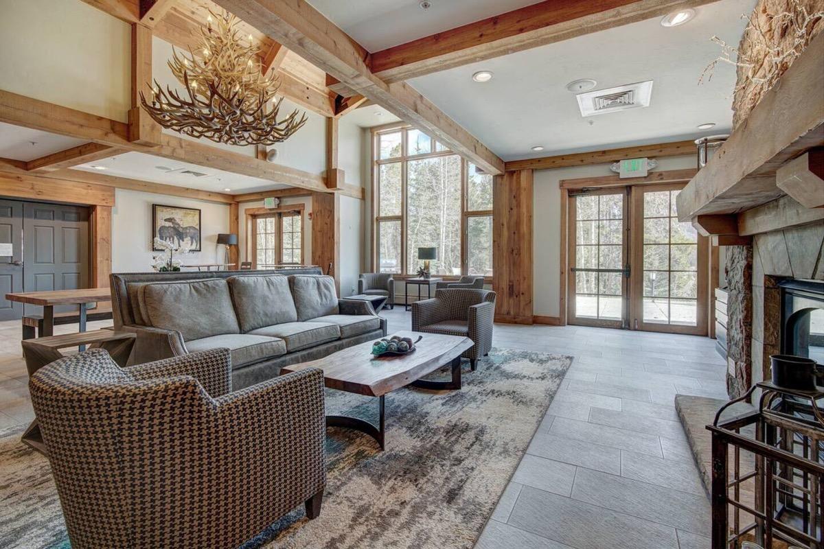 The lobby of the main lodge at Mountain Thunder, with a stone fireplace and timber beams