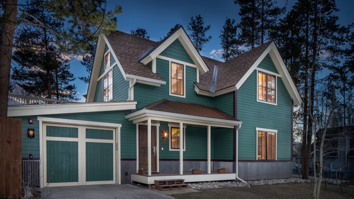 The great room of a four-bedroom residence in Breckenridge, lit in the evening