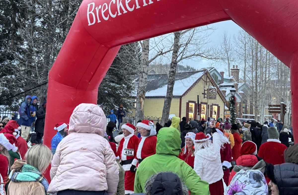 Runners in Santa suits gathered under the inflatable start arch on Main Street